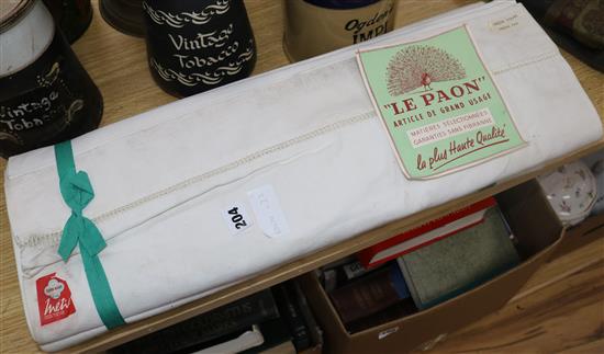 Two ribbon tied sets of linen sheets with label Le Paon